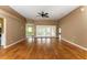 Spacious living room features hardwood floors, multiple doorways, neutral paint and a ceiling fan at 16017 Johns Lake Rd, Clermont, FL 34711