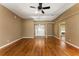 Spacious living room with hardwood floors, ceiling fan, and view of the front entry at 16017 Johns Lake Rd, Clermont, FL 34711