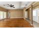 Open-concept living room featuring hardwood floors, ample lighting, and access to the front door at 16017 Johns Lake Rd, Clermont, FL 34711