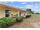 Charming covered porch with seating, surrounded by lush greenery and a well-maintained exterior at 16017 Johns Lake Rd, Clermont, FL 34711