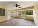 Enclosed porch with wood floors, ceiling fan, and view to the backyard at 16017 Johns Lake Rd, Clermont, FL 34711