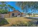 Backyard view showcasing the home's exterior, landscaping, and a wooden fence at 1842 Evergreen Dr, Edgewater, FL 32141