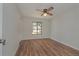 Bedroom with hardwood floors, ceiling fan, and a bright window view at 1842 Evergreen Dr, Edgewater, FL 32141