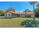 Charming single-story home with a well-manicured lawn and mature landscaping, creating excellent curb appeal at 1842 Evergreen Dr, Edgewater, FL 32141