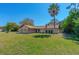 Charming single-story home with a well-manicured lawn and mature landscaping, creating excellent curb appeal at 1842 Evergreen Dr, Edgewater, FL 32141