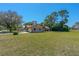 Single story home boasting a manicured front lawn and lush, mature trees at 1842 Evergreen Dr, Edgewater, FL 32141