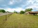 Cozy single-story home featuring a spacious front yard with a chain-link fence and convenient street access at 1842 Evergreen Dr, Edgewater, FL 32141
