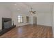Open-concept living room with hardwood floors, a modern fireplace, and large windows offering bright natural light at 1842 Evergreen Dr, Edgewater, FL 32141