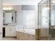 Elegant bathroom with a soaking tub, separate glass shower, and luxurious fixtures at 1851 Blissful Dr, Kissimmee, FL 34744