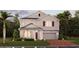 Charming two-story home with a welcoming front porch, attached garage, and beautifully landscaped front yard at 1851 Blissful Dr, Kissimmee, FL 34744