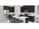 Modern kitchen with stainless steel appliances, a large center island, and dark wood cabinetry at 1851 Blissful Dr, Kissimmee, FL 34744