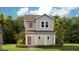 Charming two-story home featuring a covered front porch, neutral siding, and lush landscaping at 2171 Stake Out Way, Apopka, FL 32703