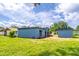 Expansive backyard with lush lawn and modern architecture at 221 E Fern Dr, Orange City, FL 32763