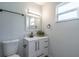 Bright bathroom features modern vanity with matte black hardware and gray backsplash at 221 E Fern Dr, Orange City, FL 32763