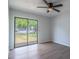Bedroom featuring a large glass slider door providing natural light and access to the backyard at 221 E Fern Dr, Orange City, FL 32763