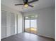 Bedroom featuring new flooring, ceiling fan and a sliding glass door to the outside at 221 E Fern Dr, Orange City, FL 32763