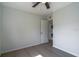 Bedroom featuring a ceiling fan and a closet with a stacked washer and dryer at 221 E Fern Dr, Orange City, FL 32763