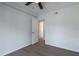 Bedroom features new flooring and an open door leading into another room at 221 E Fern Dr, Orange City, FL 32763