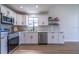 Bright modern kitchen with white cabinets, stainless steel appliances, and light wood floors at 221 E Fern Dr, Orange City, FL 32763