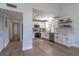 Bright modern kitchen with white cabinets, stainless steel appliances, and light wood floors at 221 E Fern Dr, Orange City, FL 32763