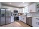 Bright modern kitchen with white cabinets, stainless steel appliances, and light wood floors at 221 E Fern Dr, Orange City, FL 32763