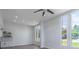 View of the open-concept living room featuring recessed lighting and large windows allowing natural light to enter the space at 221 E Fern Dr, Orange City, FL 32763