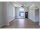 Bright living room featuring lots of natural light from large windows, a ceiling fan, and luxury vinyl flooring at 221 E Fern Dr, Orange City, FL 32763
