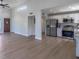 Open-concept living room with high ceilings, adjacent to modern kitchen with stainless steel appliances at 221 E Fern Dr, Orange City, FL 32763