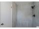 The renovated bathroom features a shower with sleek gray tiling and matte black fixtures at 221 E Fern Dr, Orange City, FL 32763