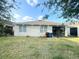 Backyard showcasing the home's exterior with windows, screened-in porch, and a green lawn at 238 Miniehaha Cir, Haines City, FL 33844