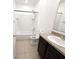 Well-lit bathroom featuring a shower-tub combo, granite countertop, and neutral tile flooring at 238 Miniehaha Cir, Haines City, FL 33844