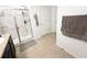 Bathroom showcasing glass-enclosed shower and towel rack against neutral-toned walls at 238 Miniehaha Cir, Haines City, FL 33844