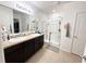 Bathroom with double sinks, granite countertop, and glass-enclosed shower at 238 Miniehaha Cir, Haines City, FL 33844