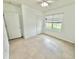 Bright bedroom featuring neutral tile flooring, and a large window providing natural light at 238 Miniehaha Cir, Haines City, FL 33844