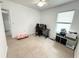 Bright bedroom featuring neutral tile flooring, ceiling fan and a window providing natural light at 238 Miniehaha Cir, Haines City, FL 33844