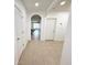 Hallway featuring a neutral tile floor and arched entryway into the living room at 238 Miniehaha Cir, Haines City, FL 33844