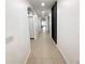 Bright hallway with neutral tile flooring and arched doorways leading to various rooms at 238 Miniehaha Cir, Haines City, FL 33844