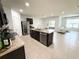 Open kitchen features a center island with stainless steel appliances and granite countertops at 238 Miniehaha Cir, Haines City, FL 33844