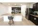 Well-appointed kitchen featuring granite counters, dark cabinetry and stainless steel refrigerator at 238 Miniehaha Cir, Haines City, FL 33844