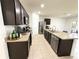 Spacious kitchen with dark cabinets, stainless steel appliances and a large granite island at 238 Miniehaha Cir, Haines City, FL 33844