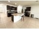 Modern kitchen with stainless appliances, granite island and dark cabinets in an open layout at 238 Miniehaha Cir, Haines City, FL 33844