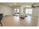 Bright living room with tile flooring, a ceiling fan and sliding glass doors to the porch at 238 Miniehaha Cir, Haines City, FL 33844