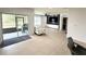 Open-concept living area with tile floors, modern furniture and access to the screened porch at 238 Miniehaha Cir, Haines City, FL 33844