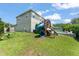 Expansive backyard featuring a playset with slide and swing set, perfect for outdoor fun and activities at 2401 Oxmoor Dr, Deland, FL 32724