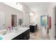 Well-lit bathroom with dual vanities, tile flooring, and ample counter space at 2401 Oxmoor Dr, Deland, FL 32724