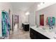 Spacious bathroom featuring dual vanities with black cabinets and modern fixtures at 2401 Oxmoor Dr, Deland, FL 32724