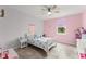 Bright bedroom with a white bed frame and a ceiling fan at 2401 Oxmoor Dr, Deland, FL 32724