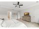 Bright bedroom with an ensuite bathroom featuring neutral tones, a large window, and a ceiling fan at 2401 Oxmoor Dr, Deland, FL 32724