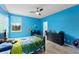 A bedroom with blue walls, a ceiling fan, and a desk area at 2401 Oxmoor Dr, Deland, FL 32724