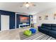 Stylish bonus room features a blue accent wall, large TV, and comfortable seating for relaxation at 2401 Oxmoor Dr, Deland, FL 32724